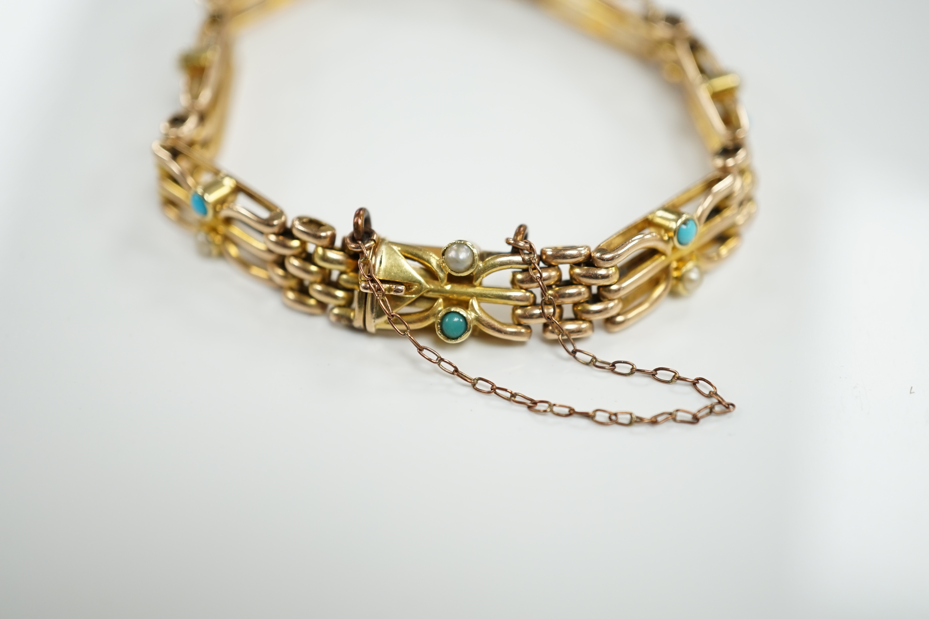 An Edwardian 15ct, turquoise and seed pearl set gate link bracelet, 18cm, gross weight 16.7 grams.